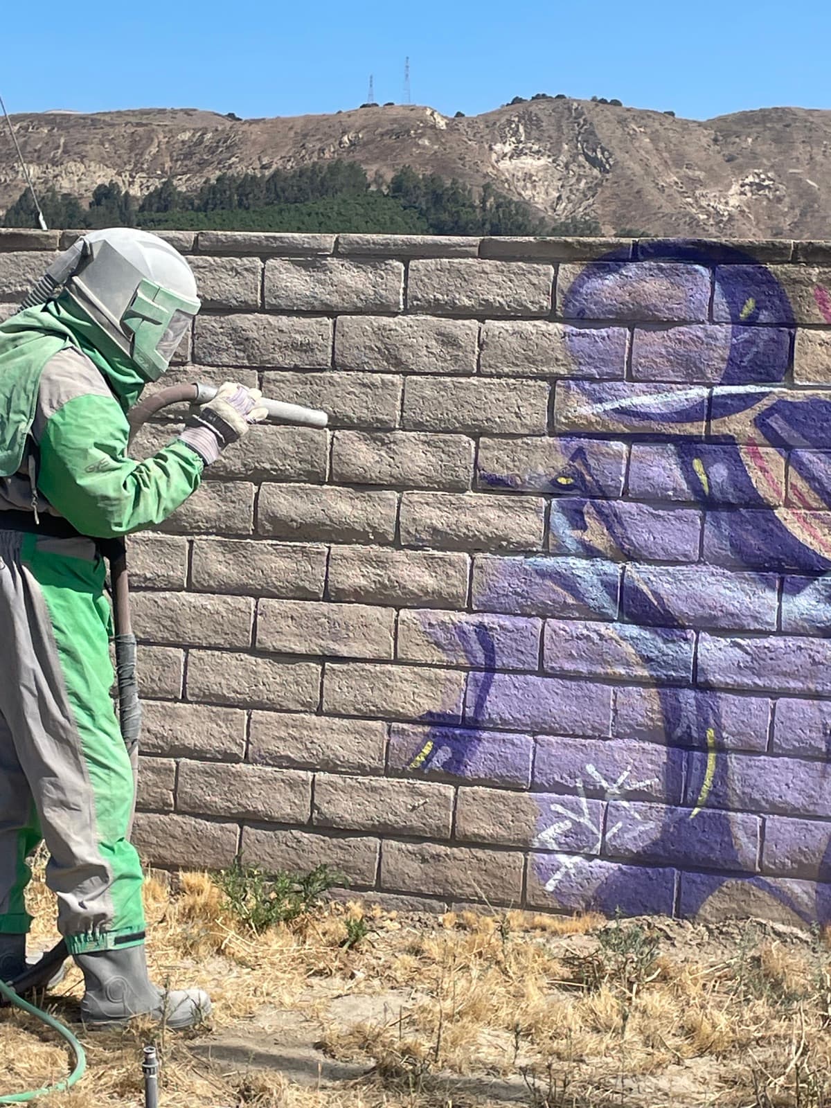 Graffiti removal from block wall during dustless blasting