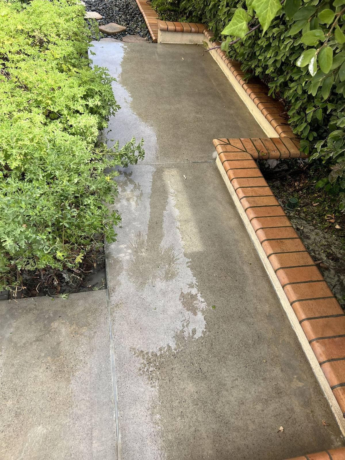 Side walkway and house exterior after coating removal by AAFB Blasting