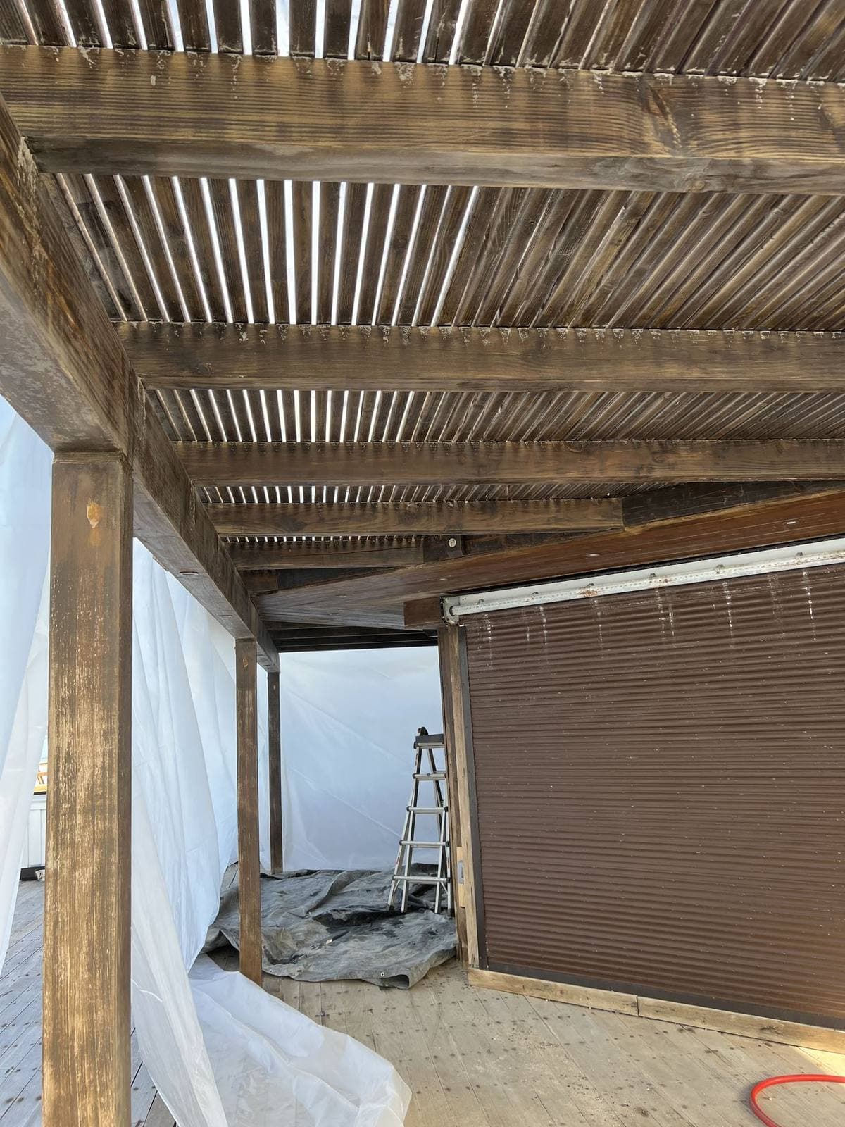 Painted deck and exposed beams before walnut blasting