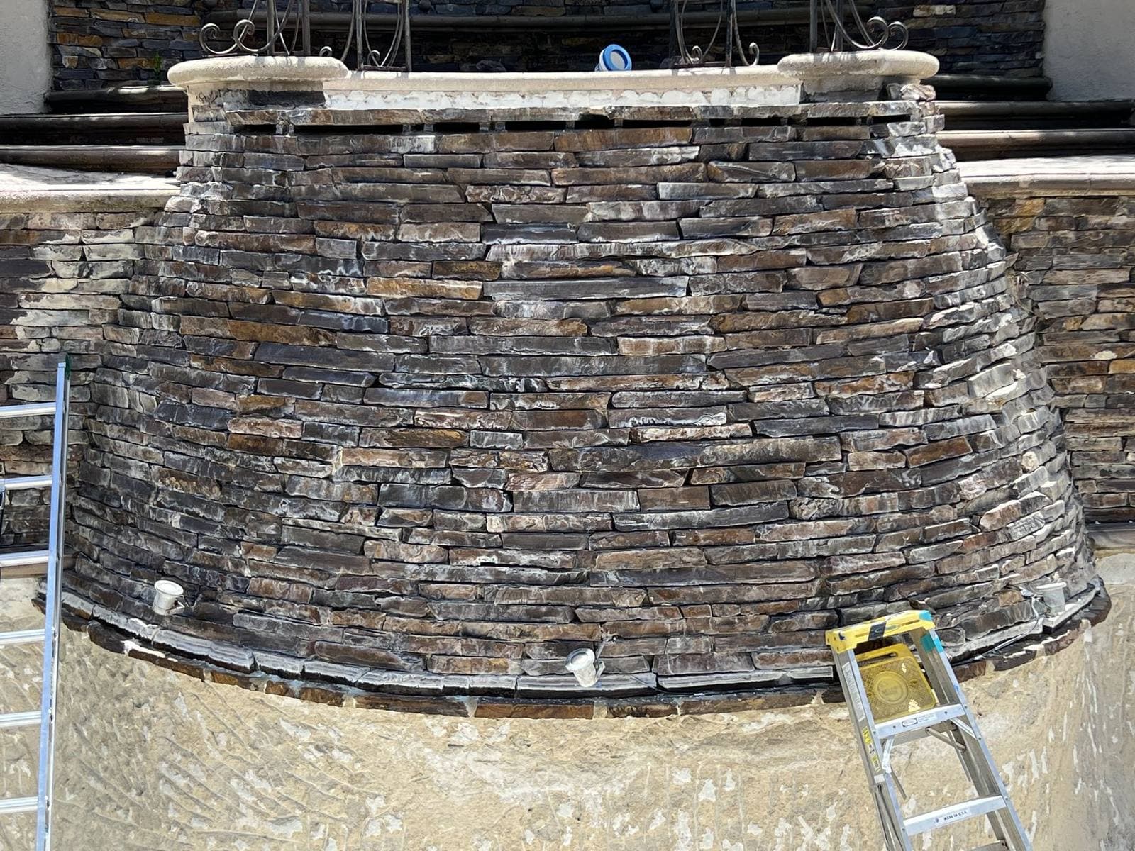 Pool waterfall feature with calcium build-up before blasting