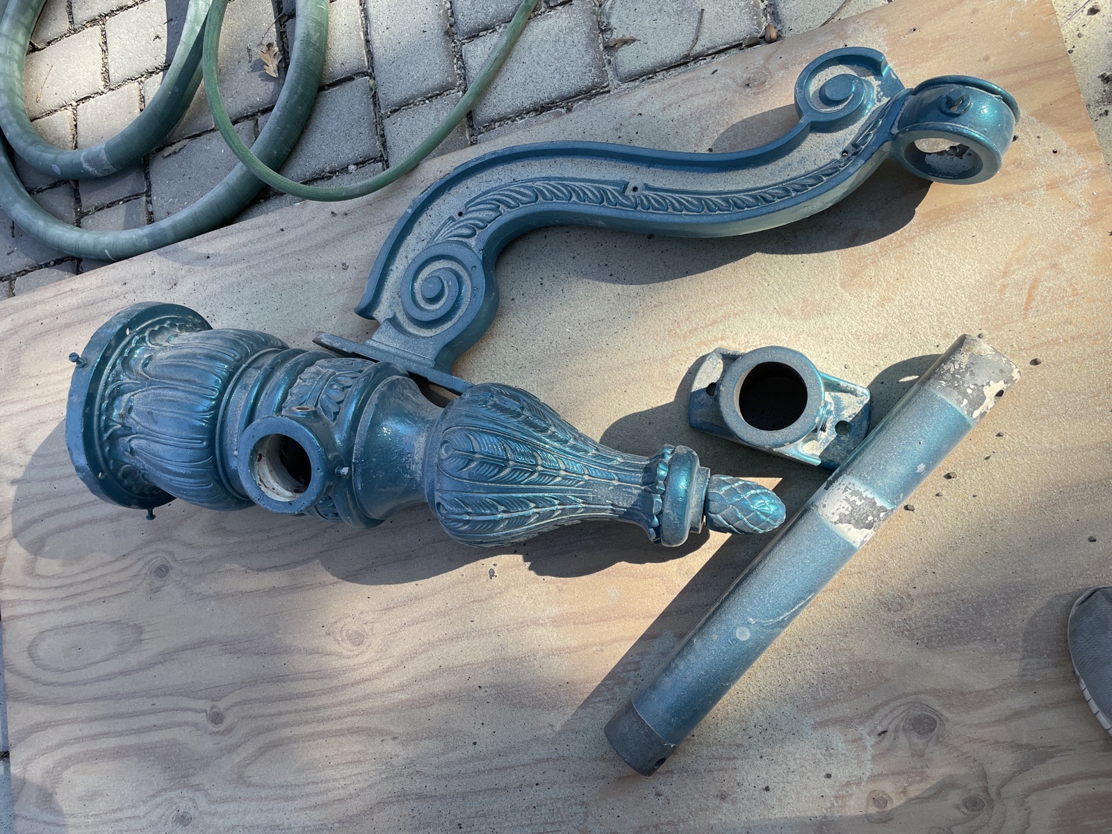 Ornate lamp post parts after blasting
