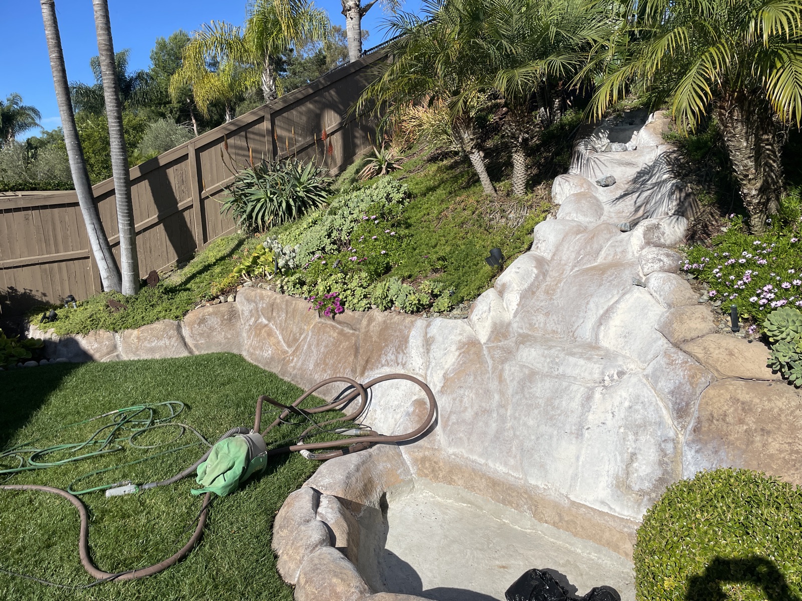 Rock waterfall feature cleaning